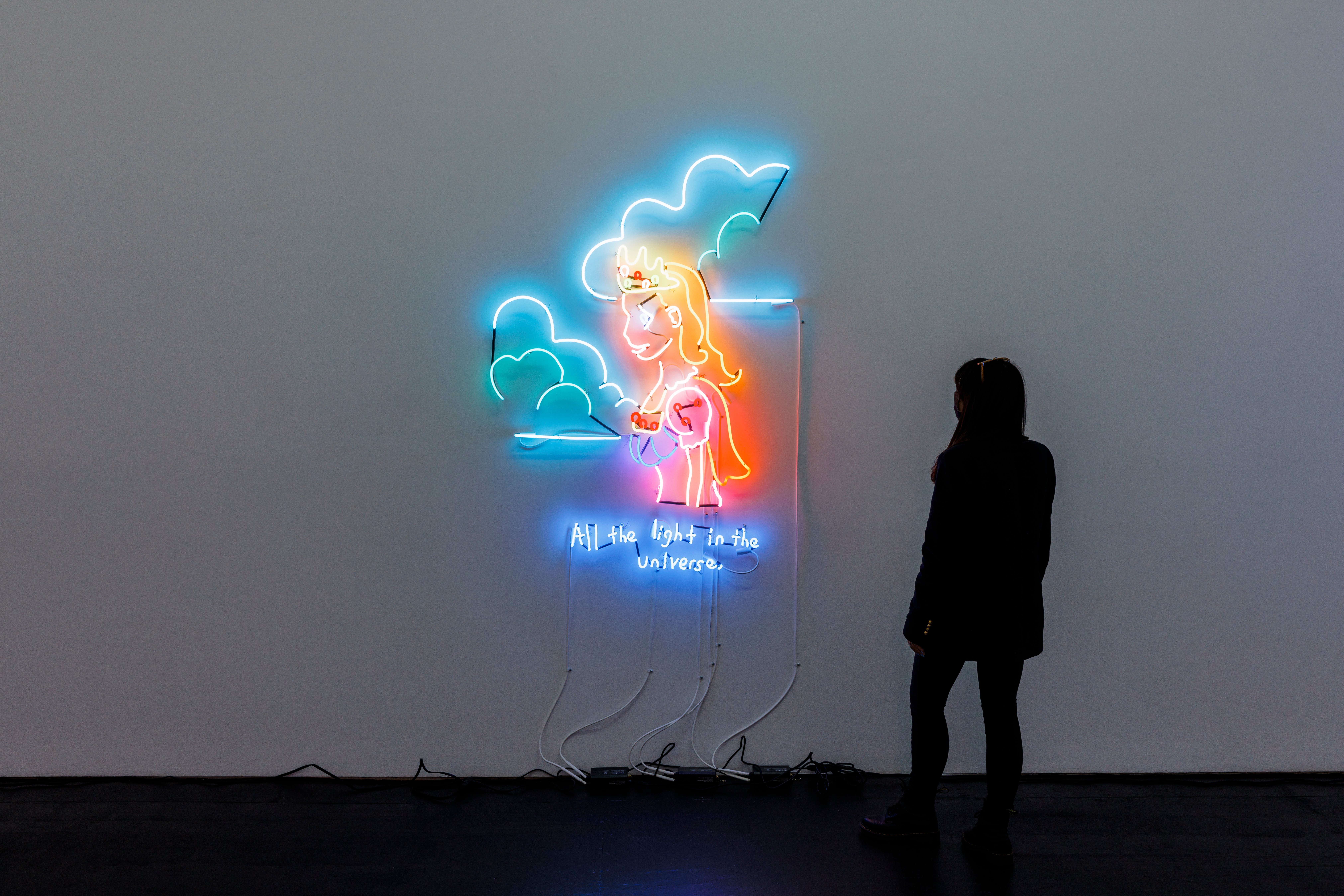 Image of a woman looking at light art